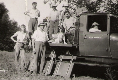 Men Standing Around A Truck