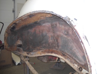 Rust and damage to a wheel well.