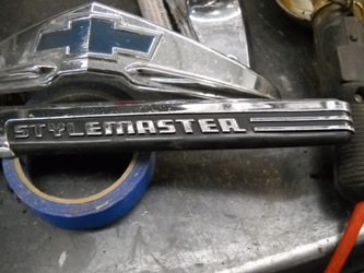 Chevy and Stylemaster emblems before restoration.